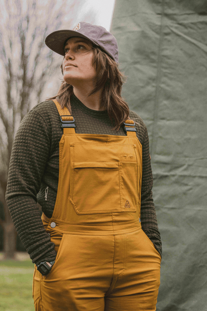 3/4 Lifestyle photo of Ecotrek Overalls in Caramel