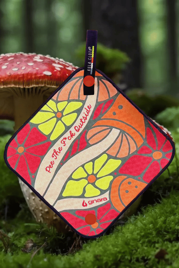 Kula with Warm Orange, Pink and Yellow Tones with Mushroom and Floral Design. Text on Kula says "Pee The F*ck Outside"