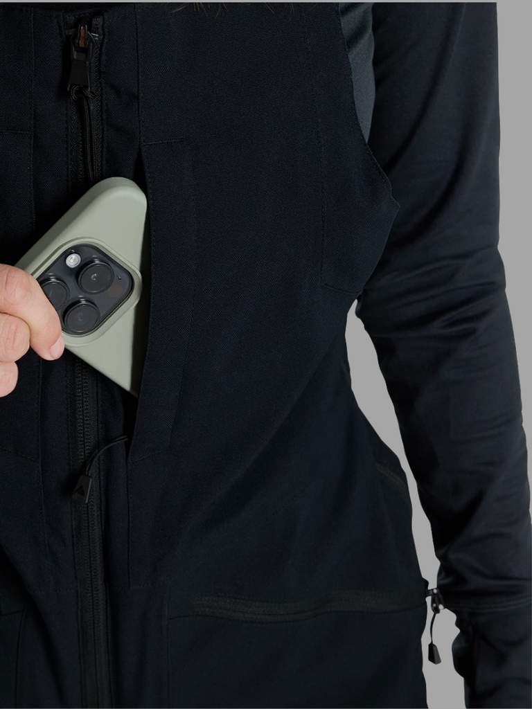 Model highlighting zippered chest pocket in Burton Bib in Black.