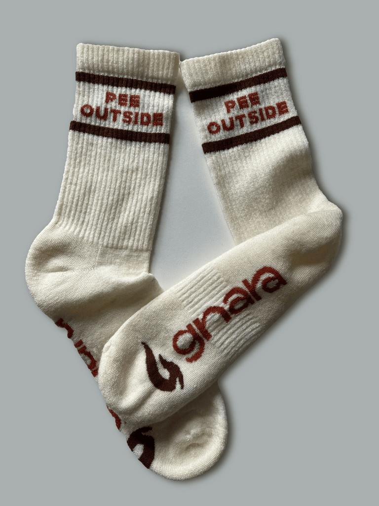 Flat lay of "Pee Outside" Socks