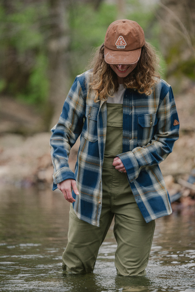 Lifestyle photo in water wearing Ecotrek overalls in Olive