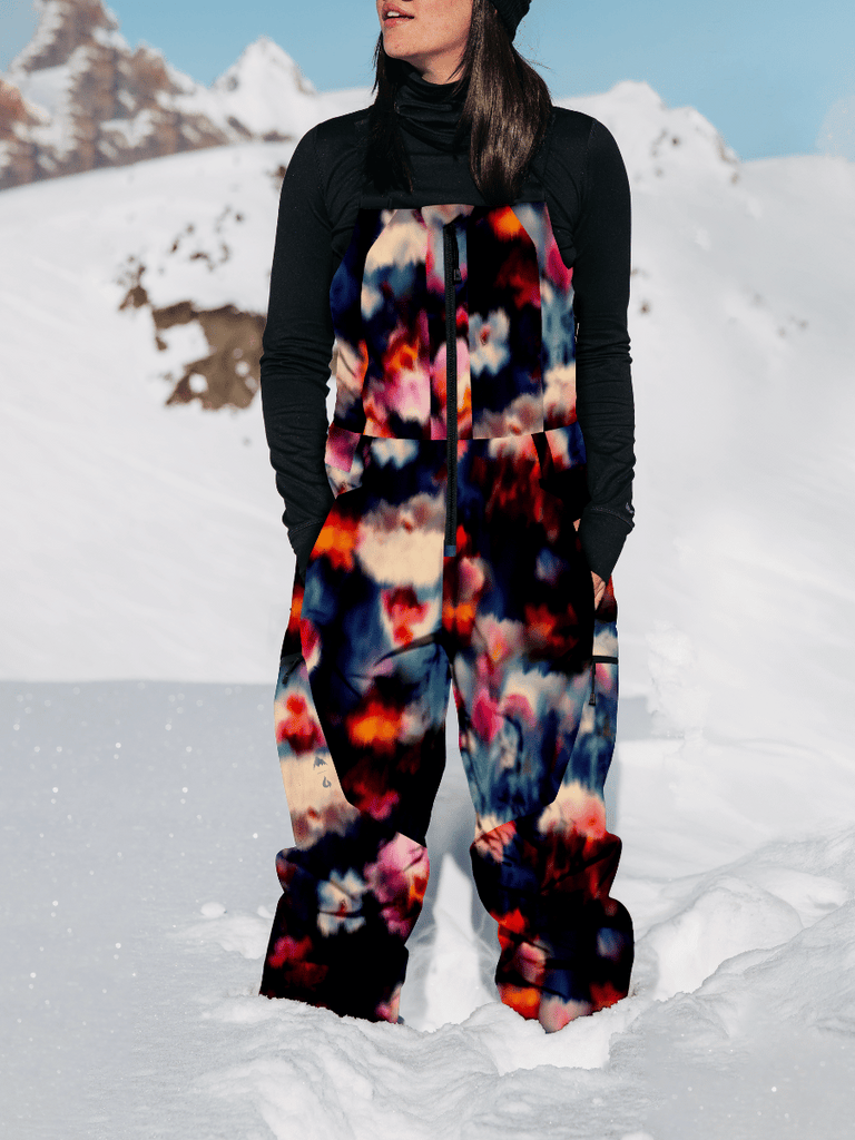 Lifestyle photo of Bib in Floral blur color, in the snow model looking in the distance